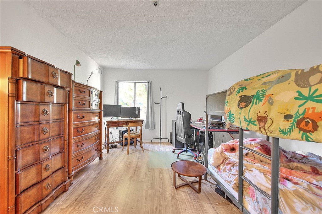 700 West 3rd Street, Unit A111 Santa Ana, CA 92701 - Photo 5 of 15 a living room with furniture and a painting on the wall