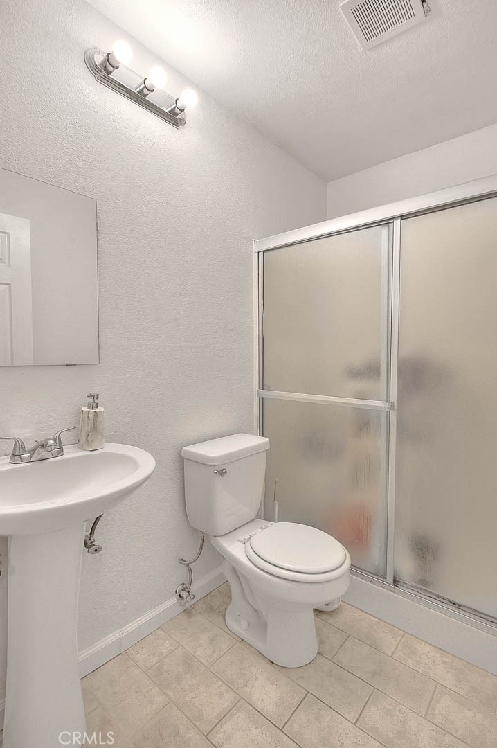 700 West 3rd Street, Unit A111 Santa Ana, CA 92701 - Photo 8 of 15 a bathroom with a toilet a sink and a shower