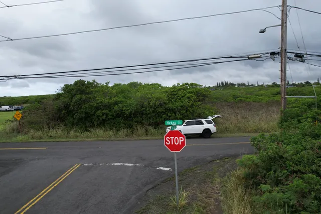 a view of a street with a couple of cars parked on road