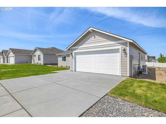 a view of backyard of house and garage
