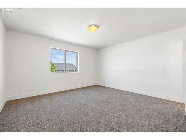 a view of an empty room and a window