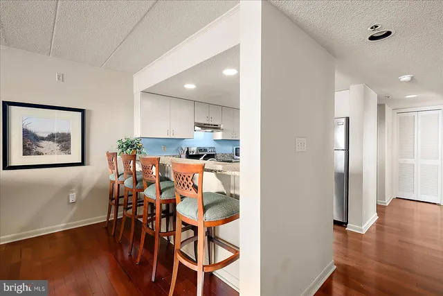 a view of a dining room with furniture and wooden floor