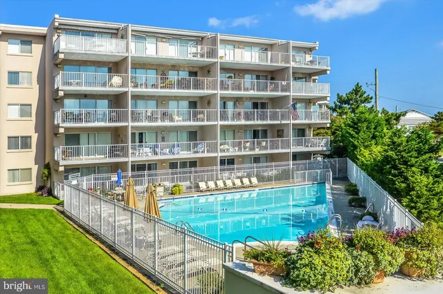 a view of building with swimming pool and outdoor space