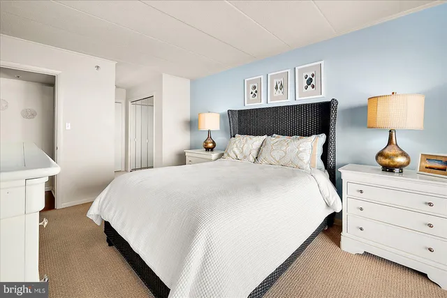 a bedroom with a bed and a night stand