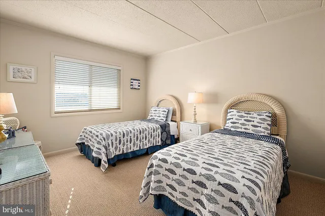 a bedroom with two beds and a dresser