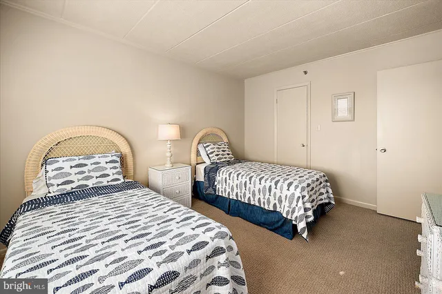 a bedroom with two beds and a window