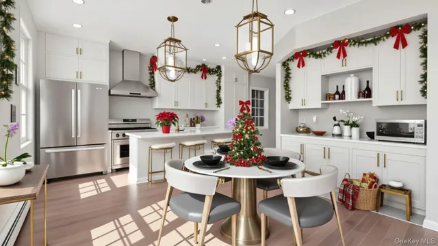 a kitchen with stainless steel appliances granite countertop a dining table and chairs