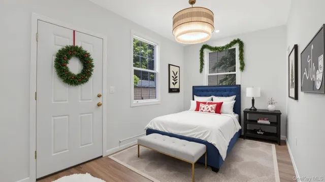 a bedroom with a bed and a chandelier