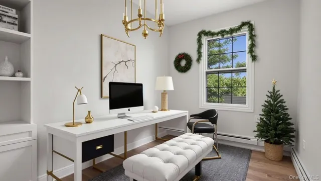 a view of a workspace with furniture and a window