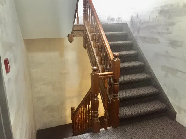 a view of staircase with white walls and a window