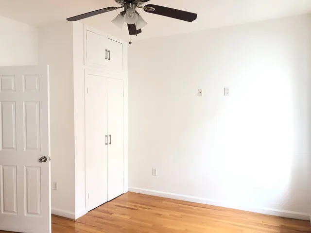 a view of a room with wooden floor