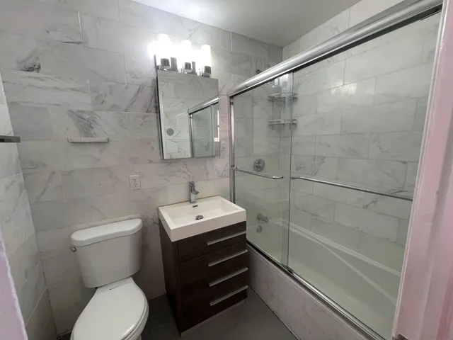 a bathroom with a toilet a sink and shower