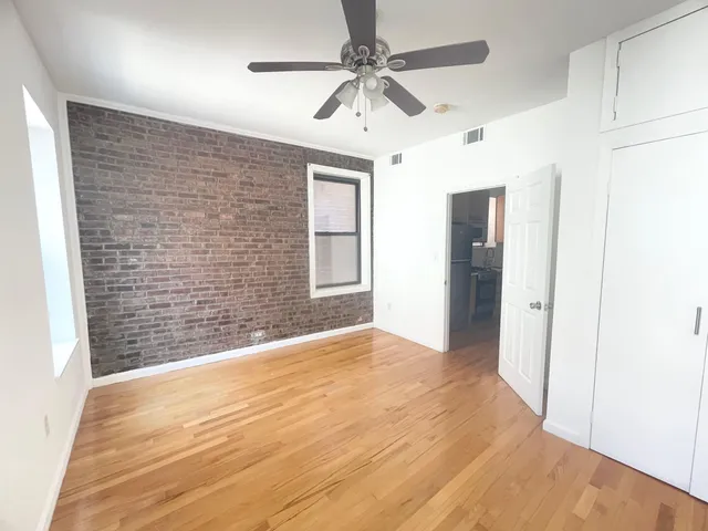 a view of an empty room with a ceiling fan