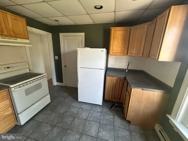 a kitchen with a refrigerator and a stove