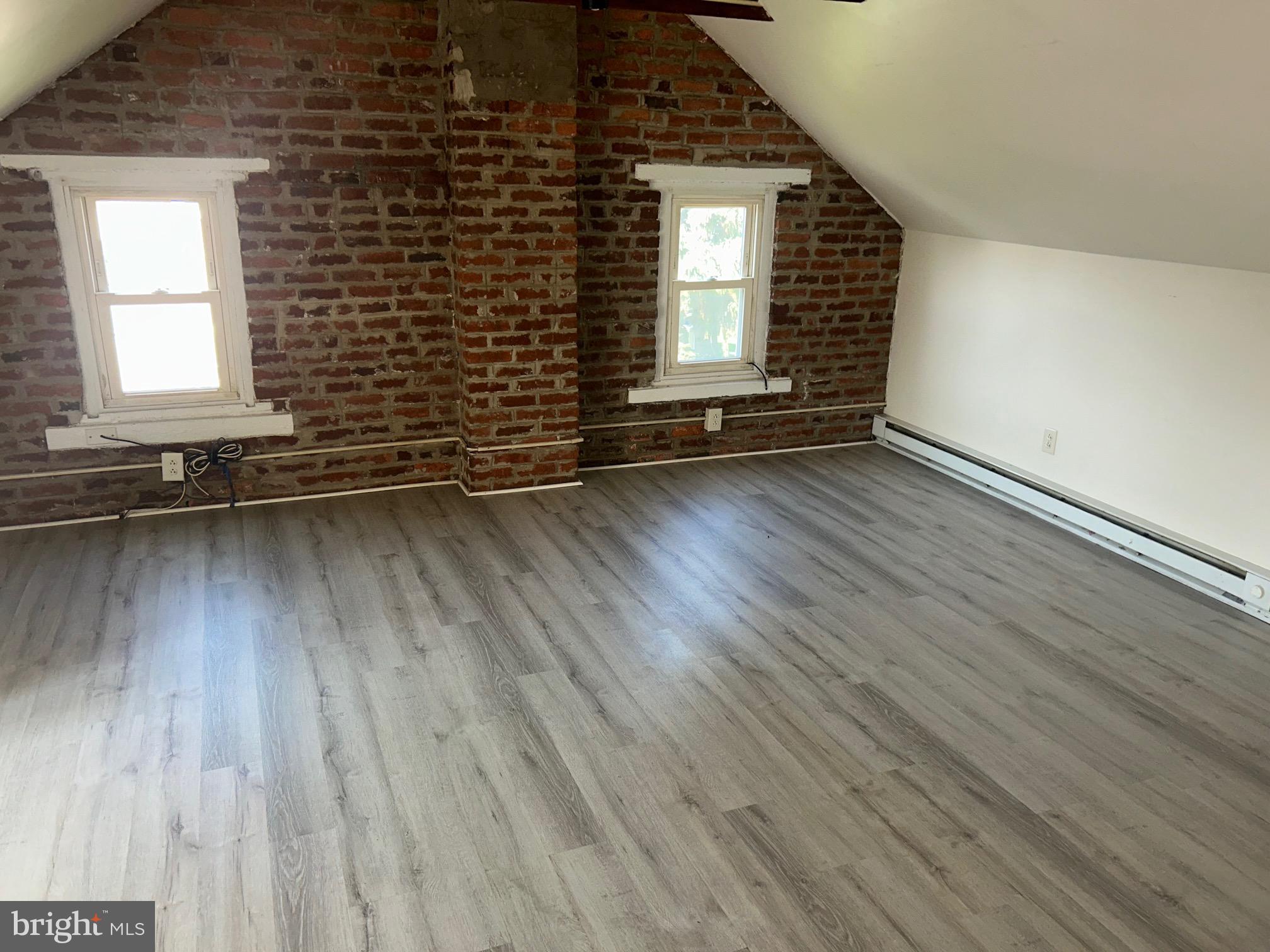 5 East Maple Street, Unit 2 Lebanon, PA 17046 - Photo 3 of 10 an empty room with wooden floor and windows