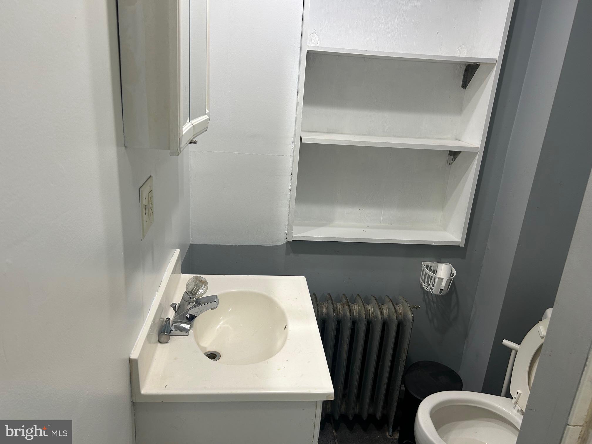5 East Maple Street, Unit 2 Lebanon, PA 17046 - Photo 5 of 10 a bathroom with a toilet sink and mirror