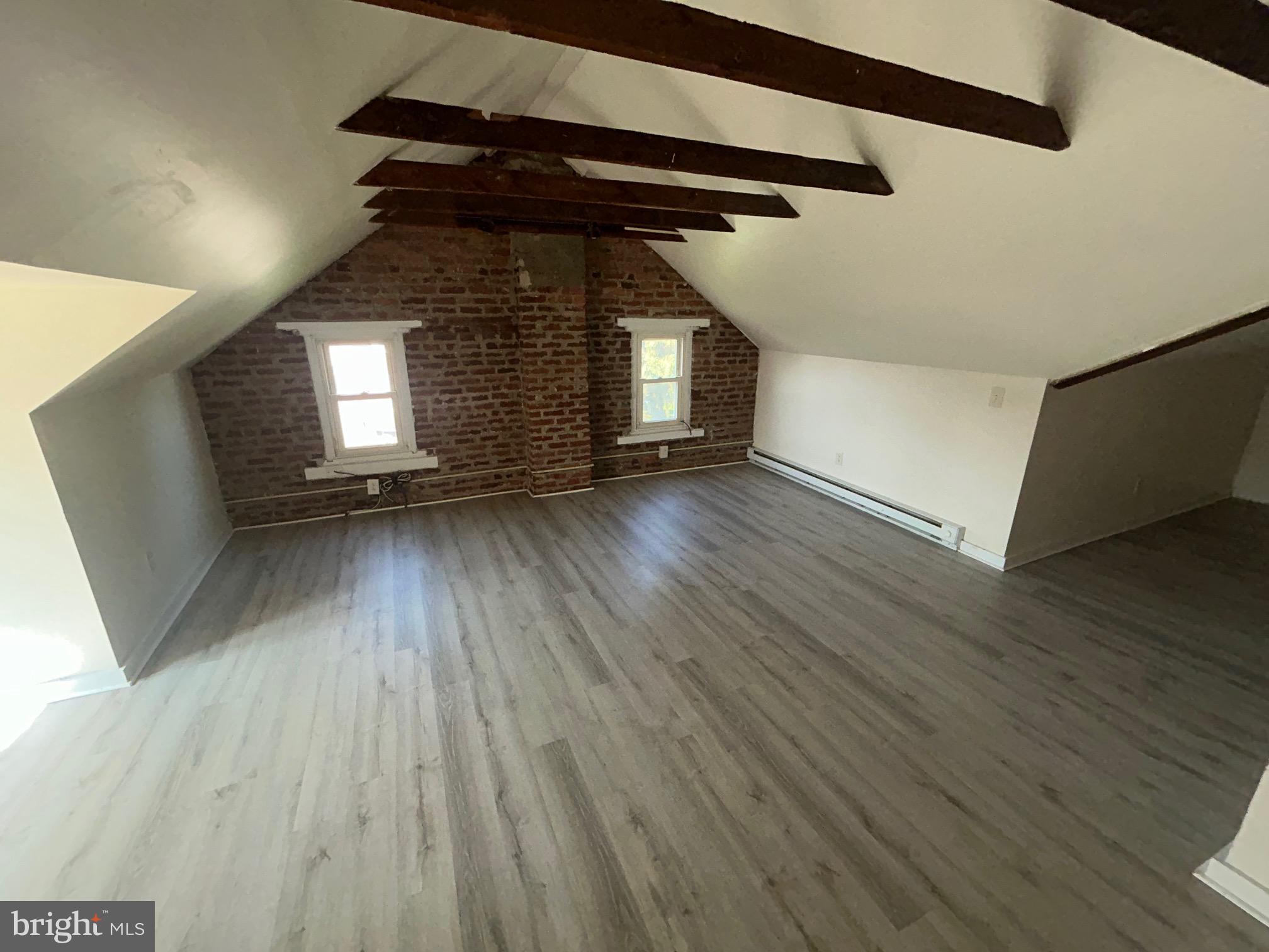 5 East Maple Street, Unit 2 Lebanon, PA 17046 - Photo 7 of 10 wooden floor in an empty room with a window