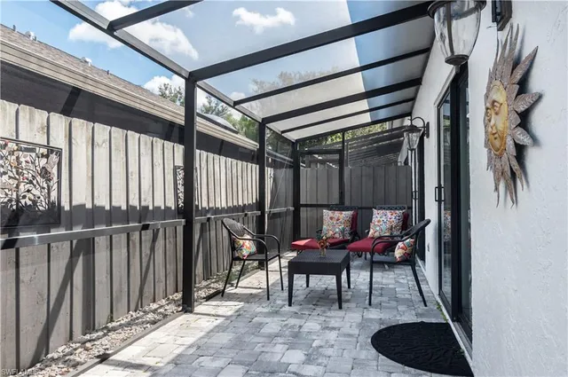 a view of a chairs and table in the balcony