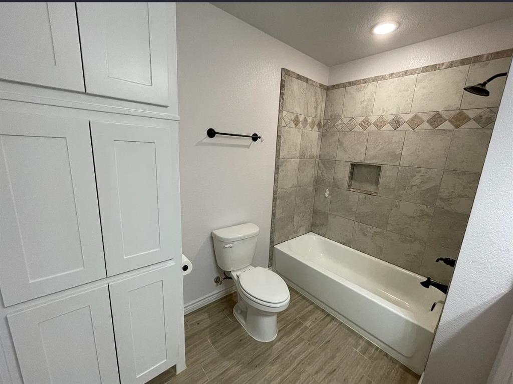 109 Spruce Tree Court Poolville, TX 76487 - Photo 11 of 21 a bathroom with a toilet and a shower