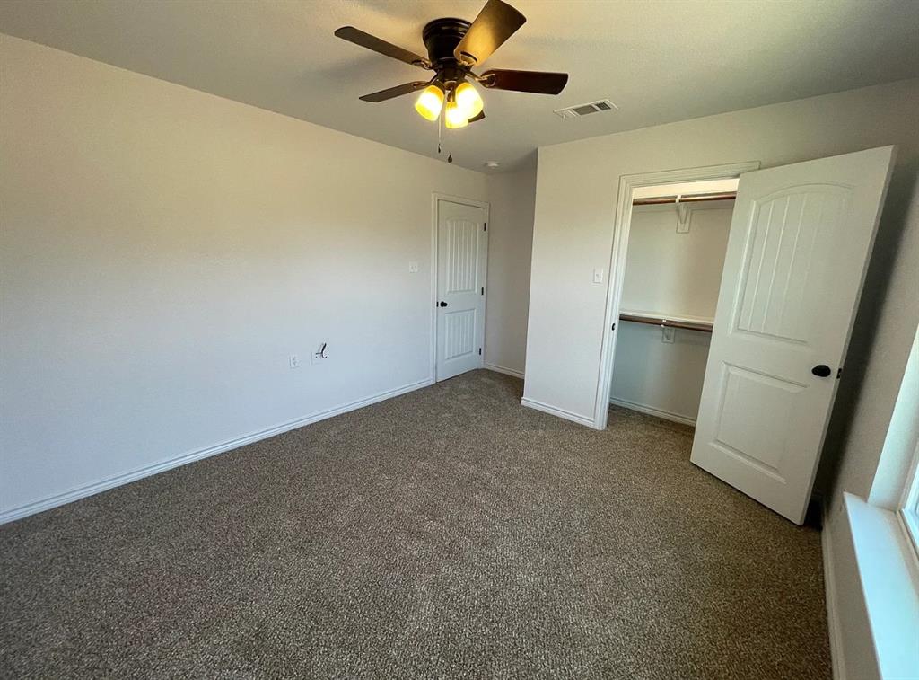 109 Spruce Tree Court Poolville, TX 76487 - Photo 15 of 21 a view of a room with a ceiling fan and a carpet
