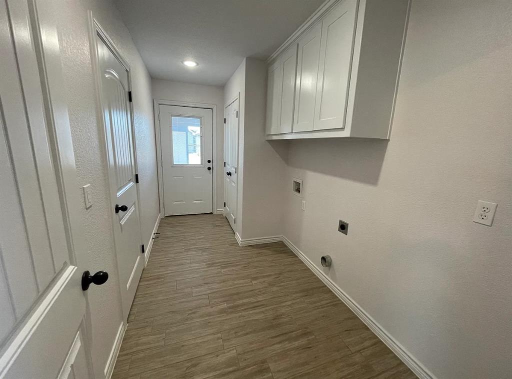 109 Spruce Tree Court Poolville, TX 76487 - Photo 19 of 21 a view of a hallway with wooden floor