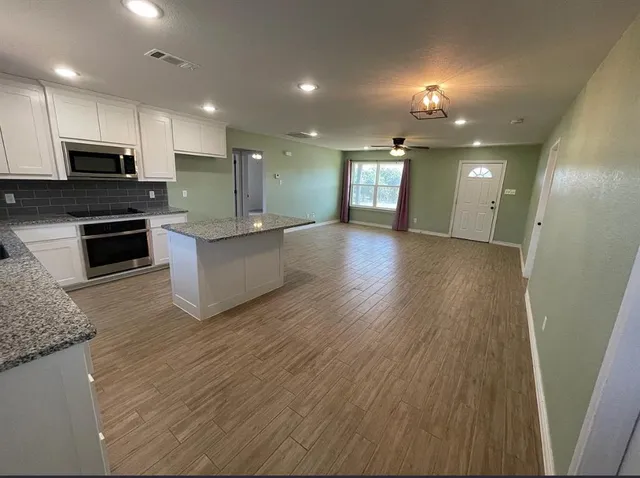 a view of kitchen with sink refrigerator and stove