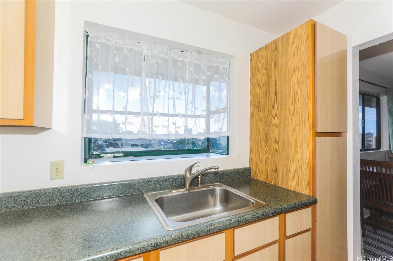 1540 Magazine Street, Unit C/3 Honolulu, HI 96822 - Photo 11 of 25 a kitchen with granite countertop a sink and a window