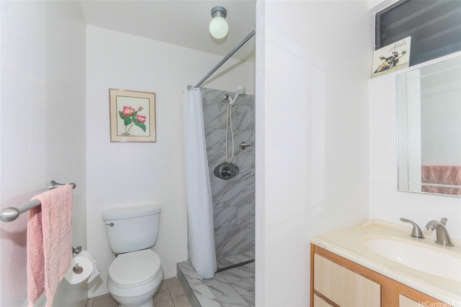 1540 Magazine Street, Unit C/3 Honolulu, HI 96822 - Photo 17 of 25 a bathroom with a sink a toilet and shower