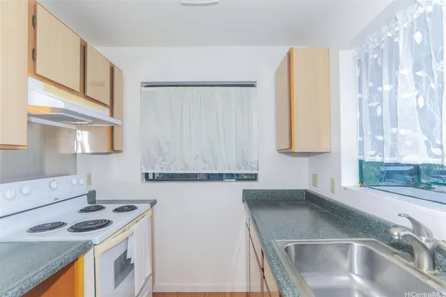 a kitchen with a sink a stove and a refrigerator