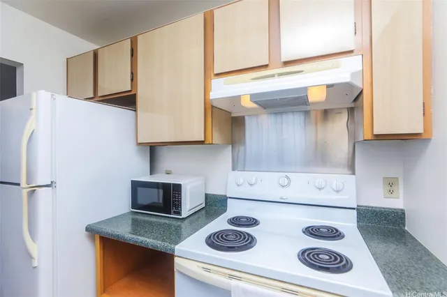 a kitchen with kitchen island white cabinets and white appliances