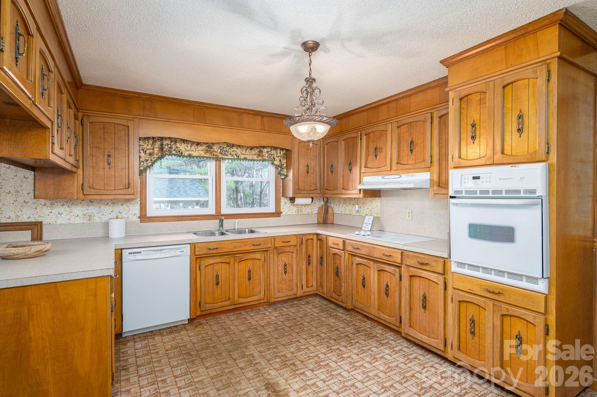 221 Lee Black Road Cherryville, NC 28021 - Photo 11 of 48 a kitchen with stainless steel appliances granite countertop a sink dishwasher stove and refrigerator with wooden cabinets