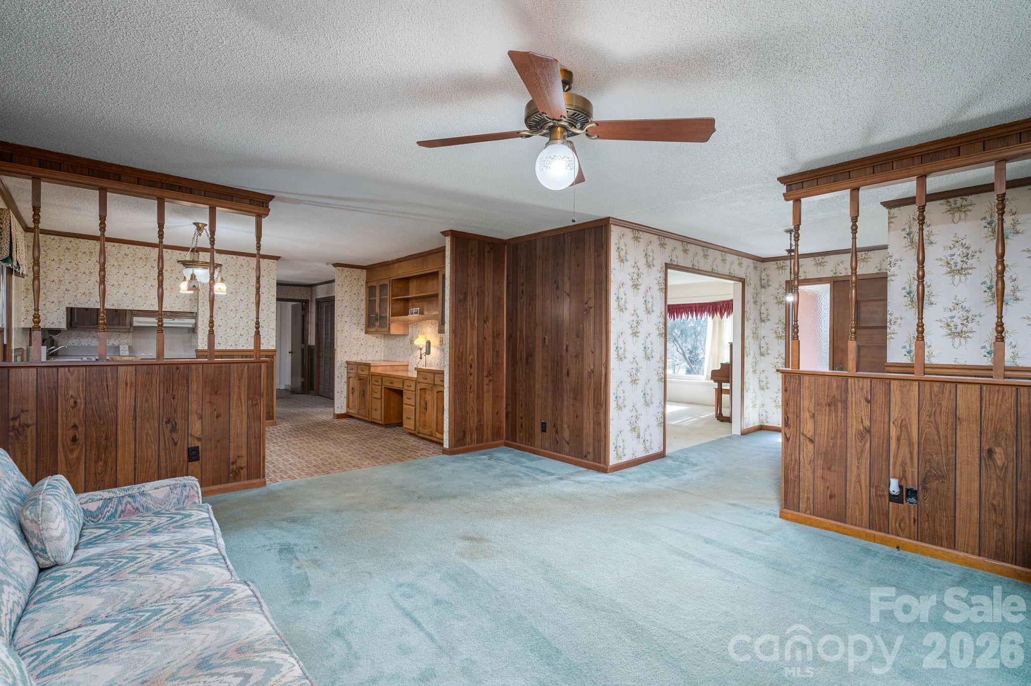 221 Lee Black Road Cherryville, NC 28021 - Photo 16 of 48 a view of a livingroom with furniture a ceiling fan and windows