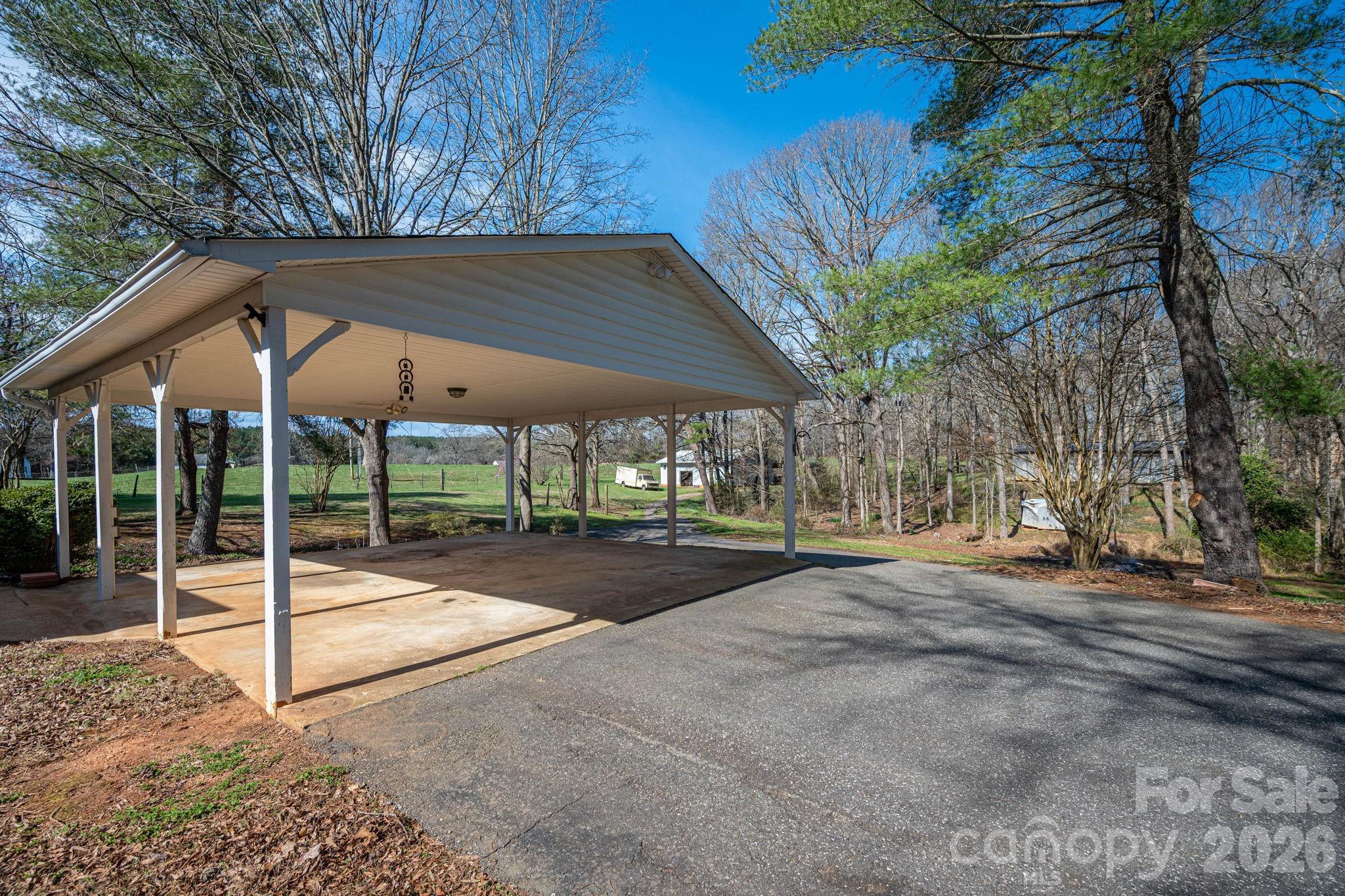 221 Lee Black Road Cherryville, NC 28021 - Photo 20 of 48 a view of patio with a table and chairs under an umbrella