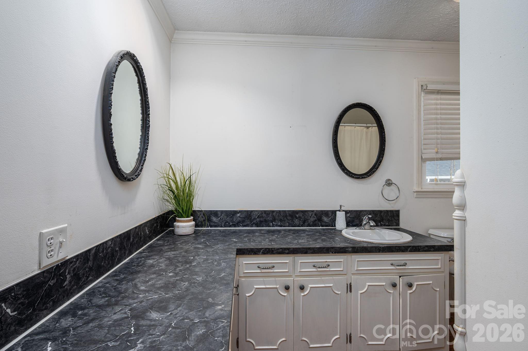 221 Lee Black Road Cherryville, NC 28021 - Photo 22 of 48 a bathroom with a granite countertop sink and a mirror