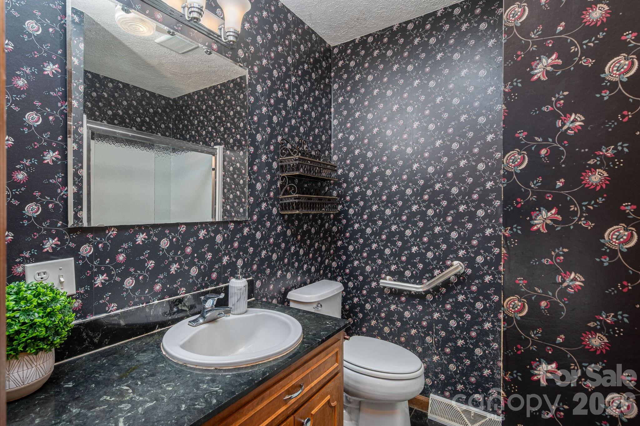 221 Lee Black Road Cherryville, NC 28021 - Photo 25 of 48 a bathroom with a granite countertop toilet sink and mirror