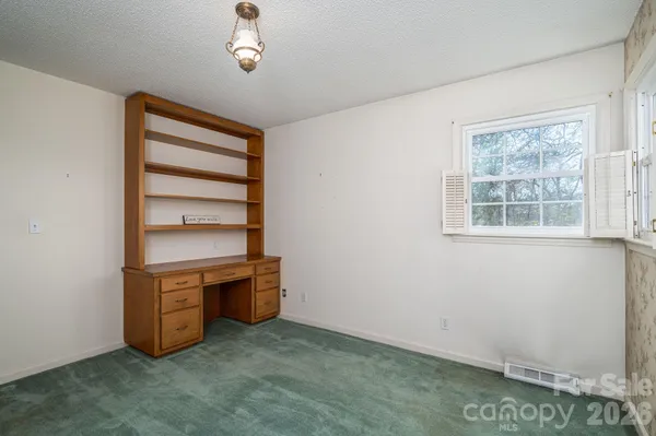 an empty room with a hallway and stairs