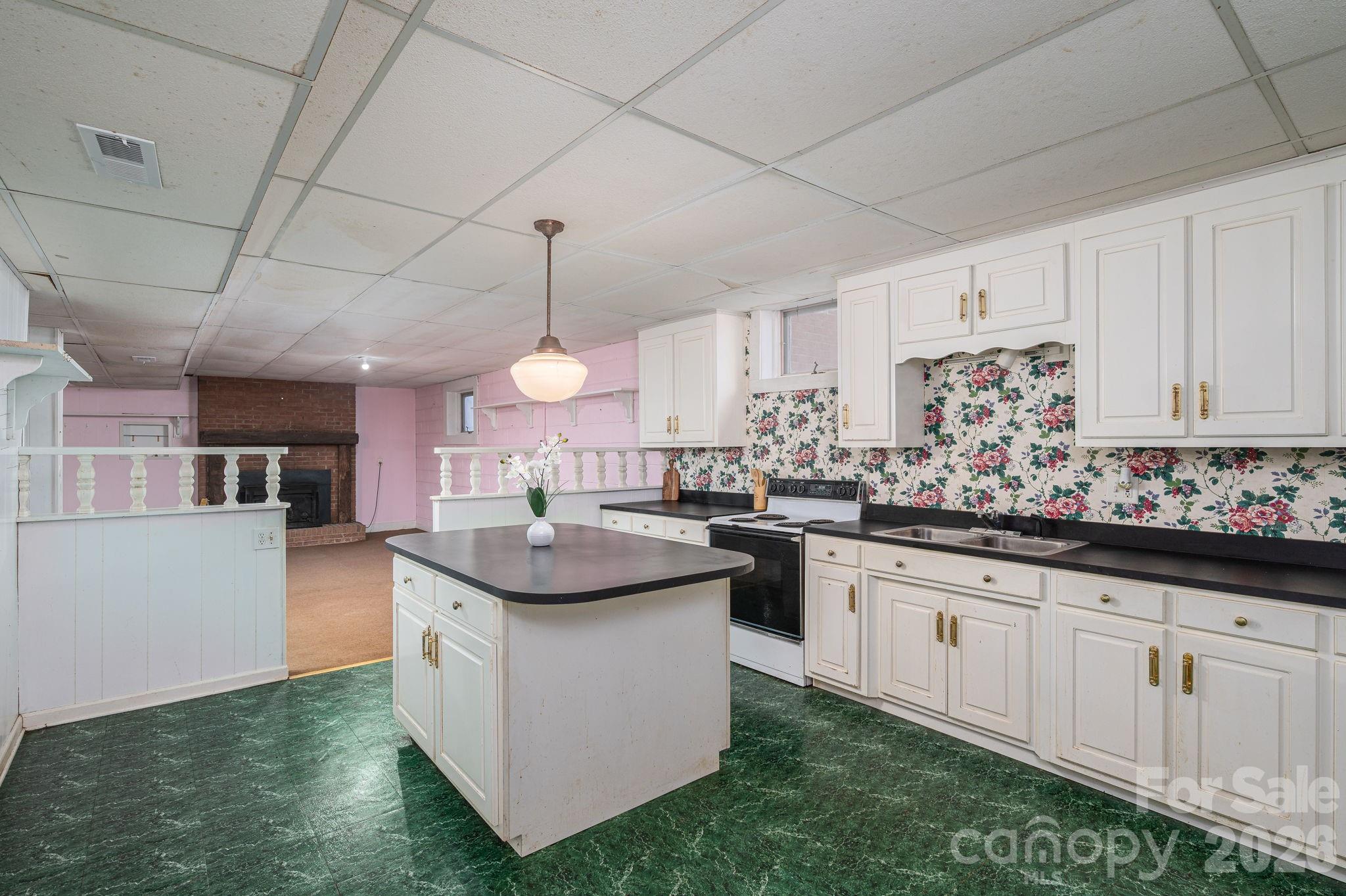 221 Lee Black Road Cherryville, NC 28021 - Photo 44 of 48 a kitchen with kitchen island granite countertop a sink a counter top space and cabinets