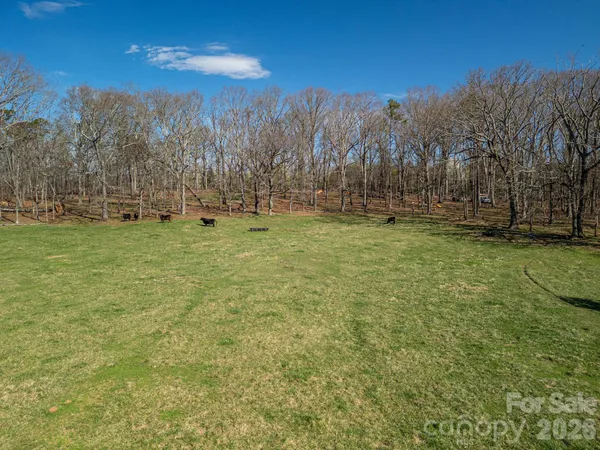 a view of a house with yard and swimming pool