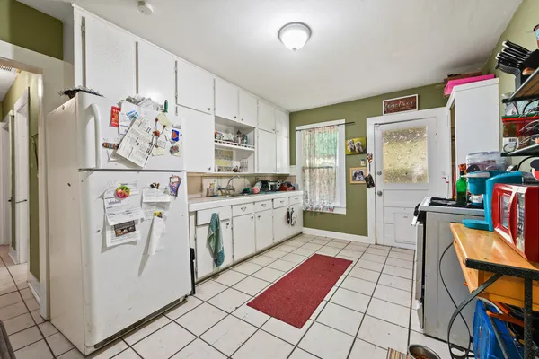 a kitchen with stainless steel appliances and white cabinets