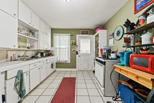 a kitchen with stainless steel appliances granite countertop a stove and cabinets