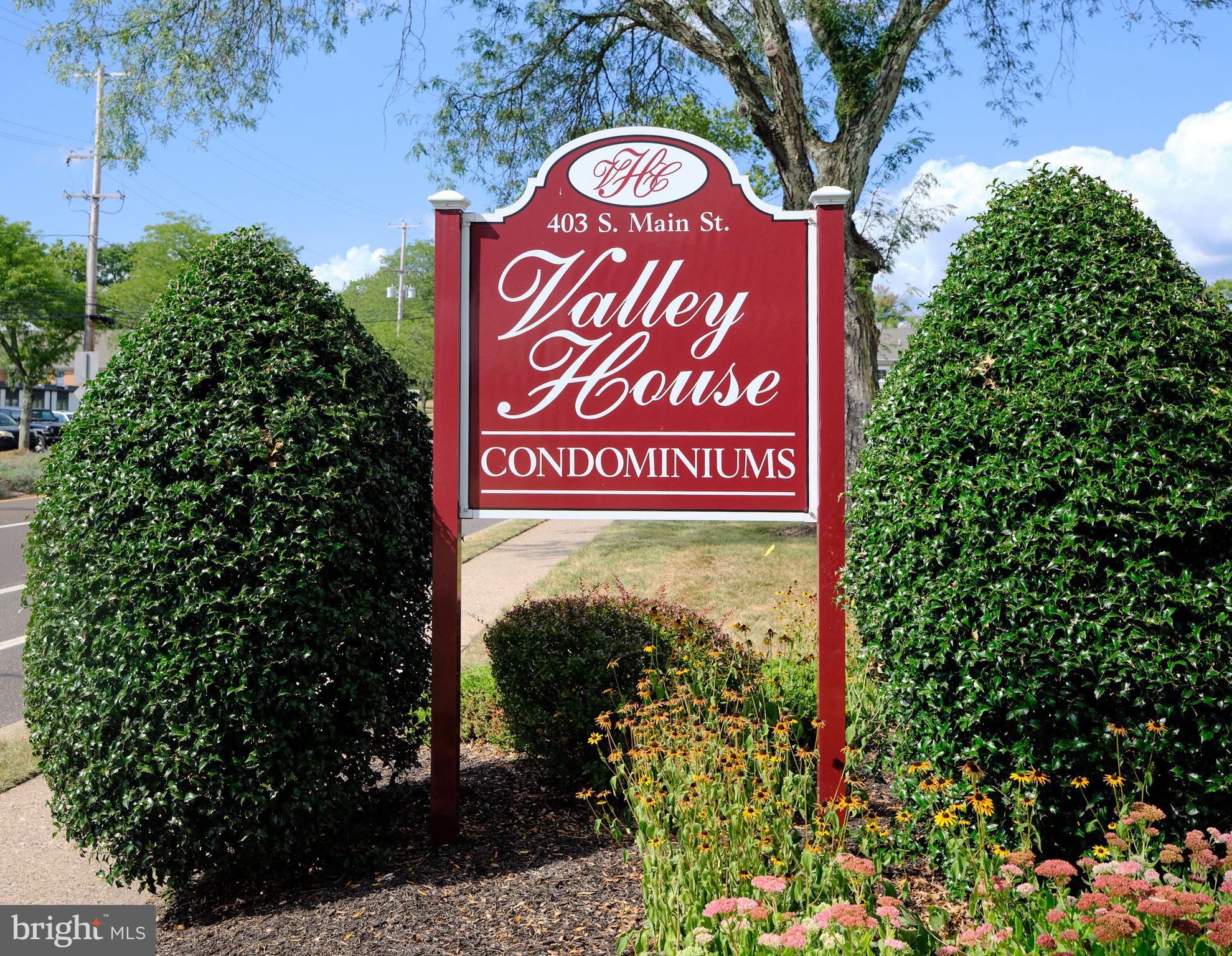 403 South Main Street, Unit S201 Doylestown, PA 18901 - Photo 13 of 13 a sign broad in front of flowers