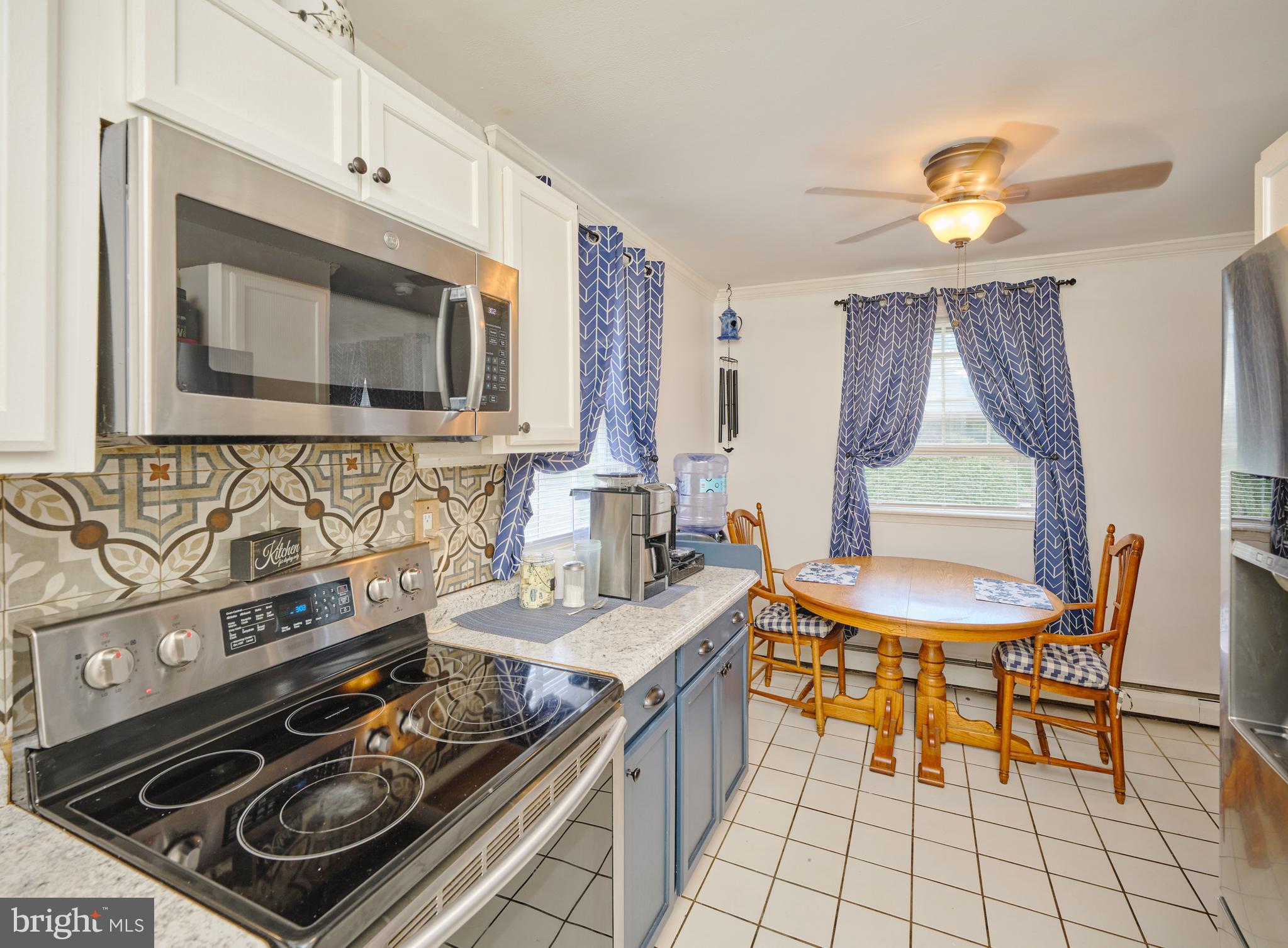403 South Main Street, Unit S201 Doylestown, PA 18901 - Photo 6 of 13 a kitchen with a stove a sink and a microwave