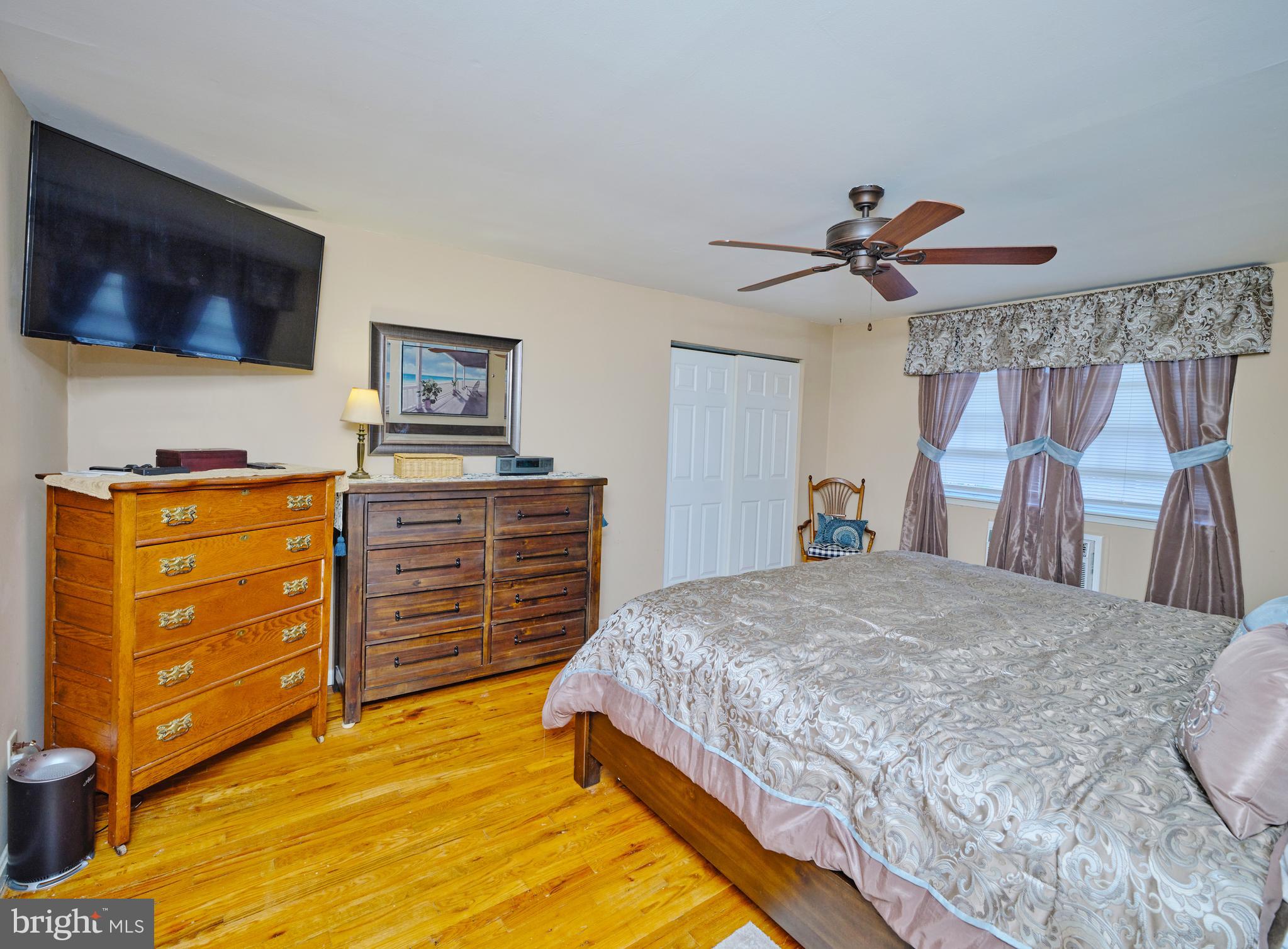 403 South Main Street, Unit S201 Doylestown, PA 18901 - Photo 8 of 13 a bedroom with a bed and a flat screen tv