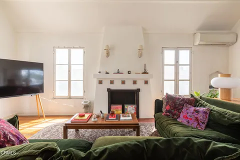 a room with a large window and wooden floor