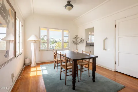 a view of a dining room with furniture and wooden floor