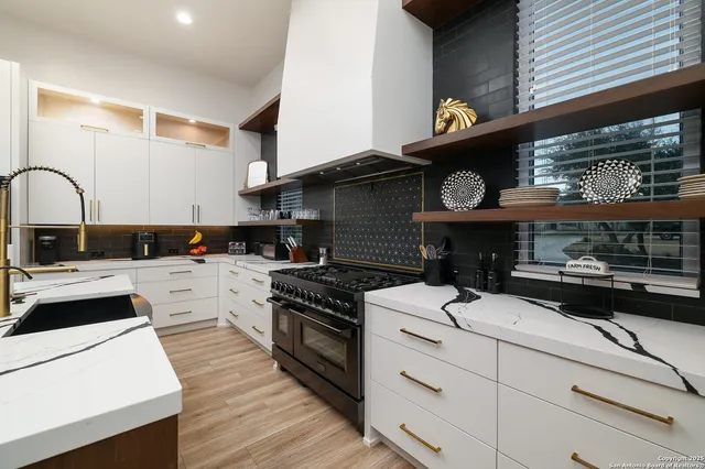 a kitchen that has a sink and a stove