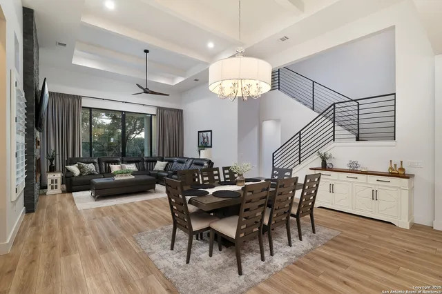 a view of a dining room with furniture wooden floor and chandelier