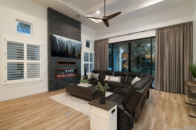 a living room with furniture a fireplace and a flat screen tv