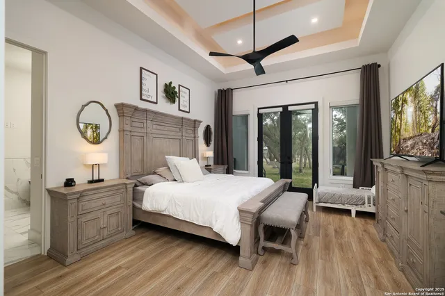 a bedroom with a bed window and a flat screen tv