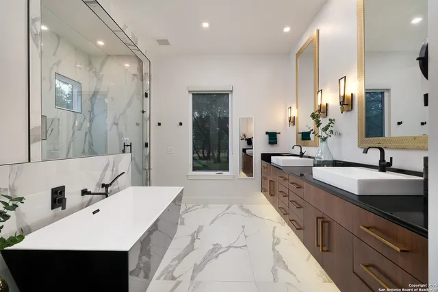 a large kitchen with kitchen island a sink stainless steel appliances and cabinets